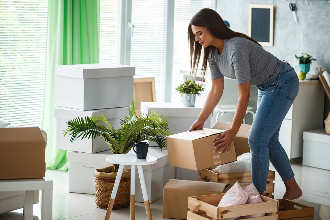 Woman organizing moving boxes in her new home