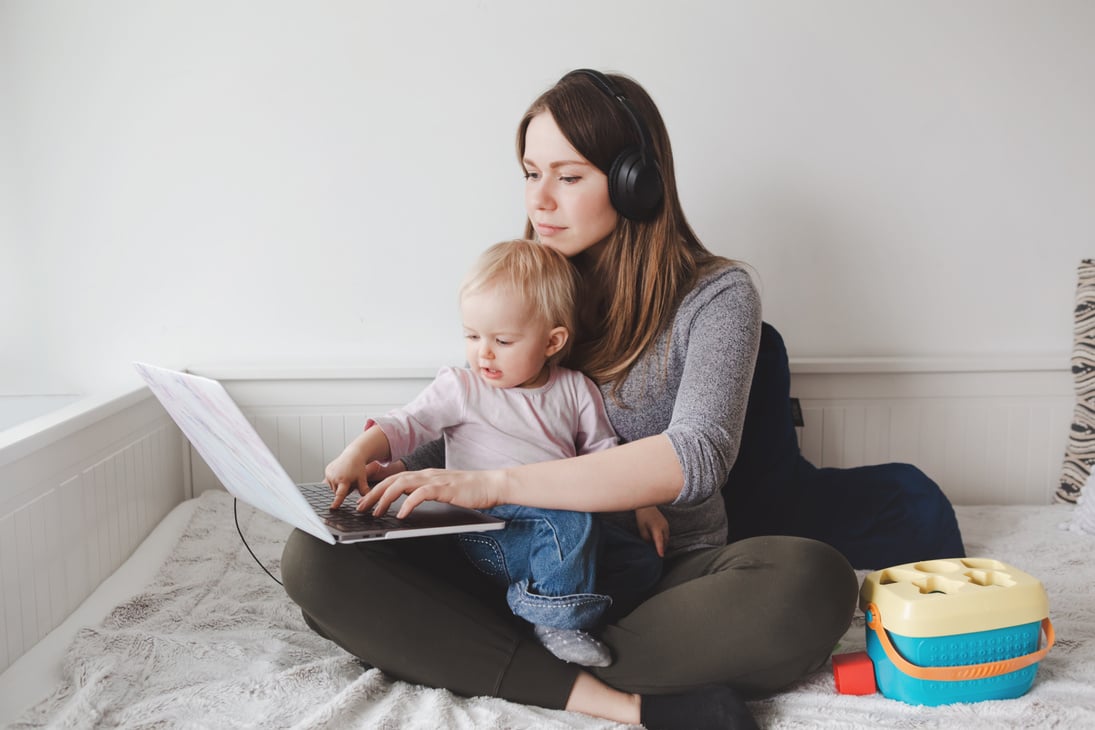 Mother Blogger with Baby Working on Laptop from Home